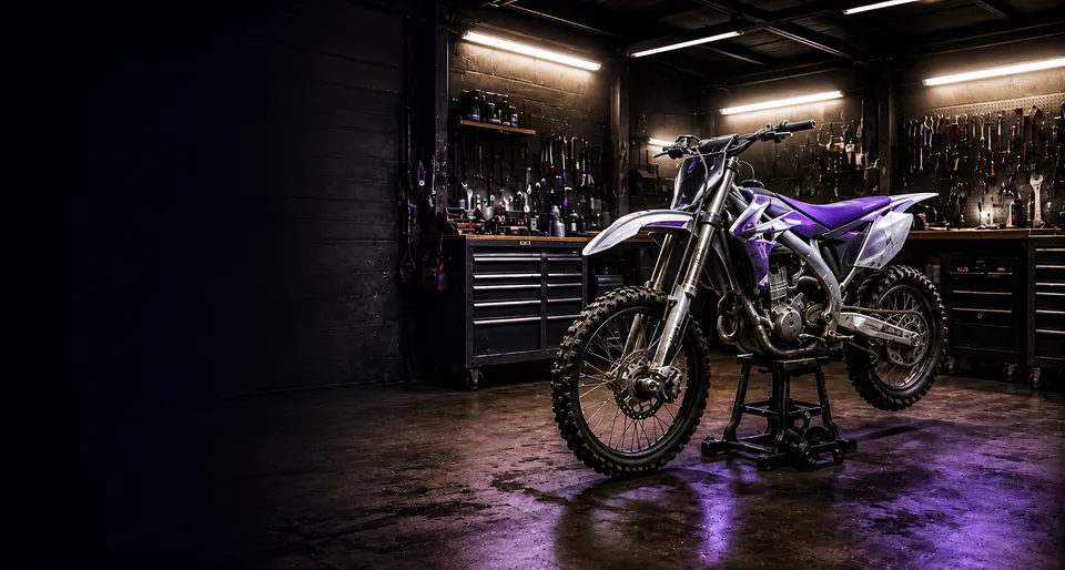 Enduro bike on a stand in a workshop, lit in RideMind purple